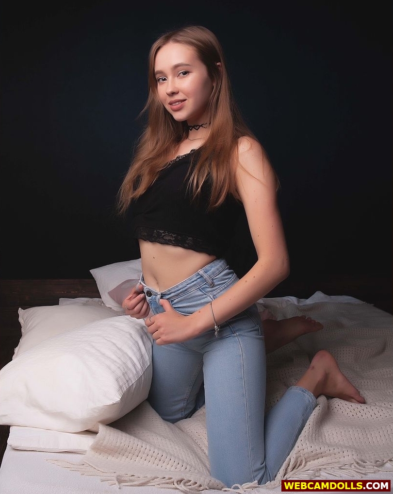 Blonde Teen Girl kneeling on Bed in Blue Denim Jean on Camdolls
